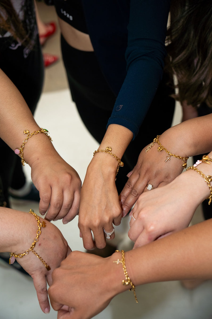 Group showing off custom charm bracelets at a charm bar event